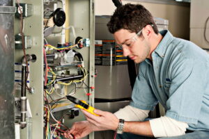 Service technician working on a heater's electrical system.