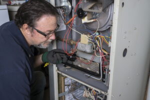 technician-inspecting-faulty-furnace