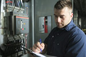 Technician-inspecting-electrical-panel-in-residential-address